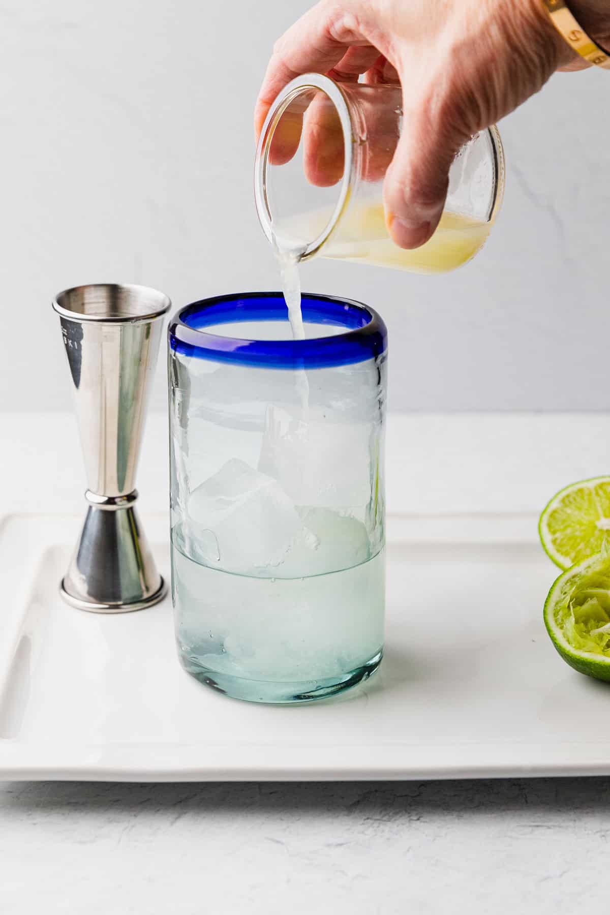Pour lime into glass.