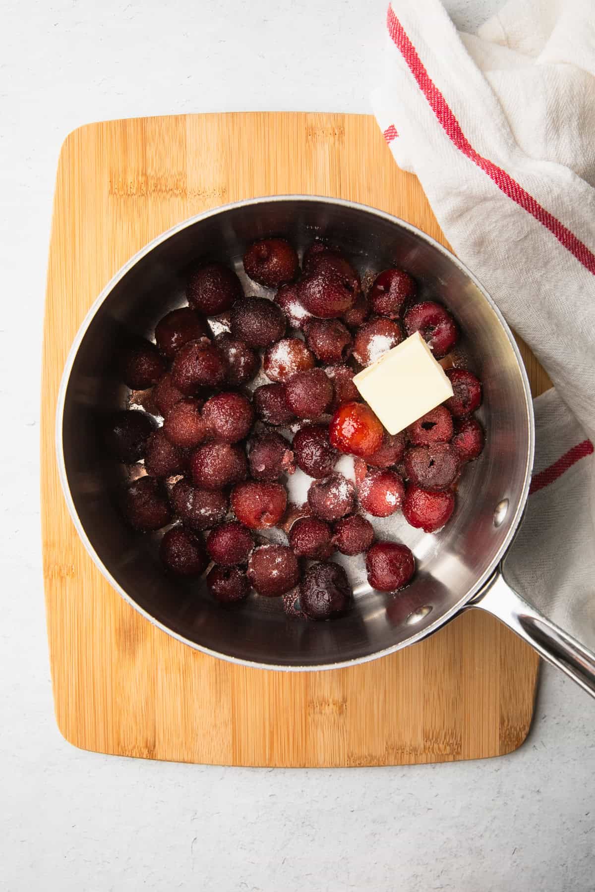 Cooking the cherries to make the cake.