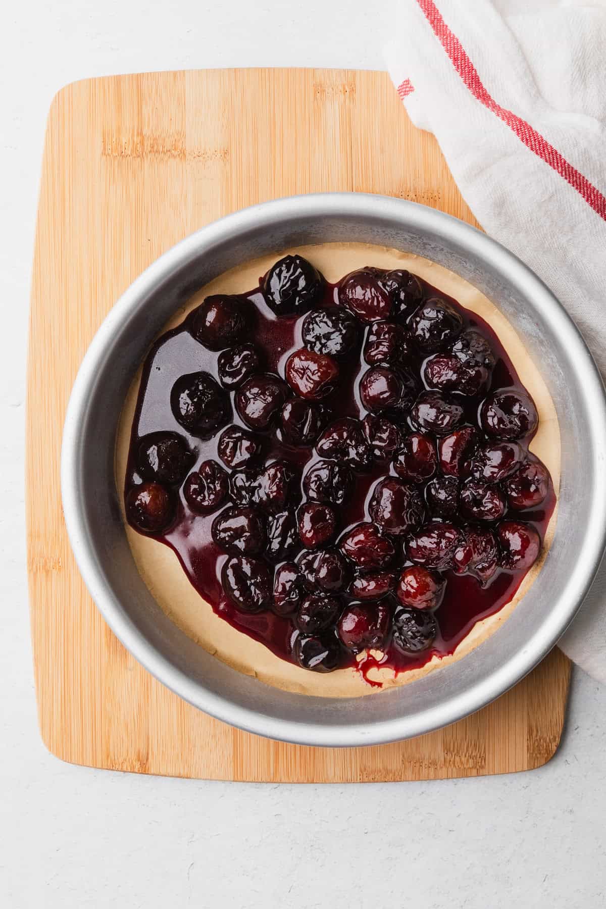 Cooked cherries in a cake pan.