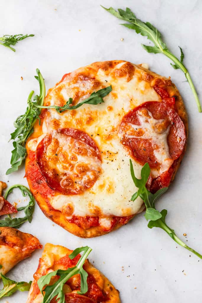 The completed air fryer naan pizza with some arugula.