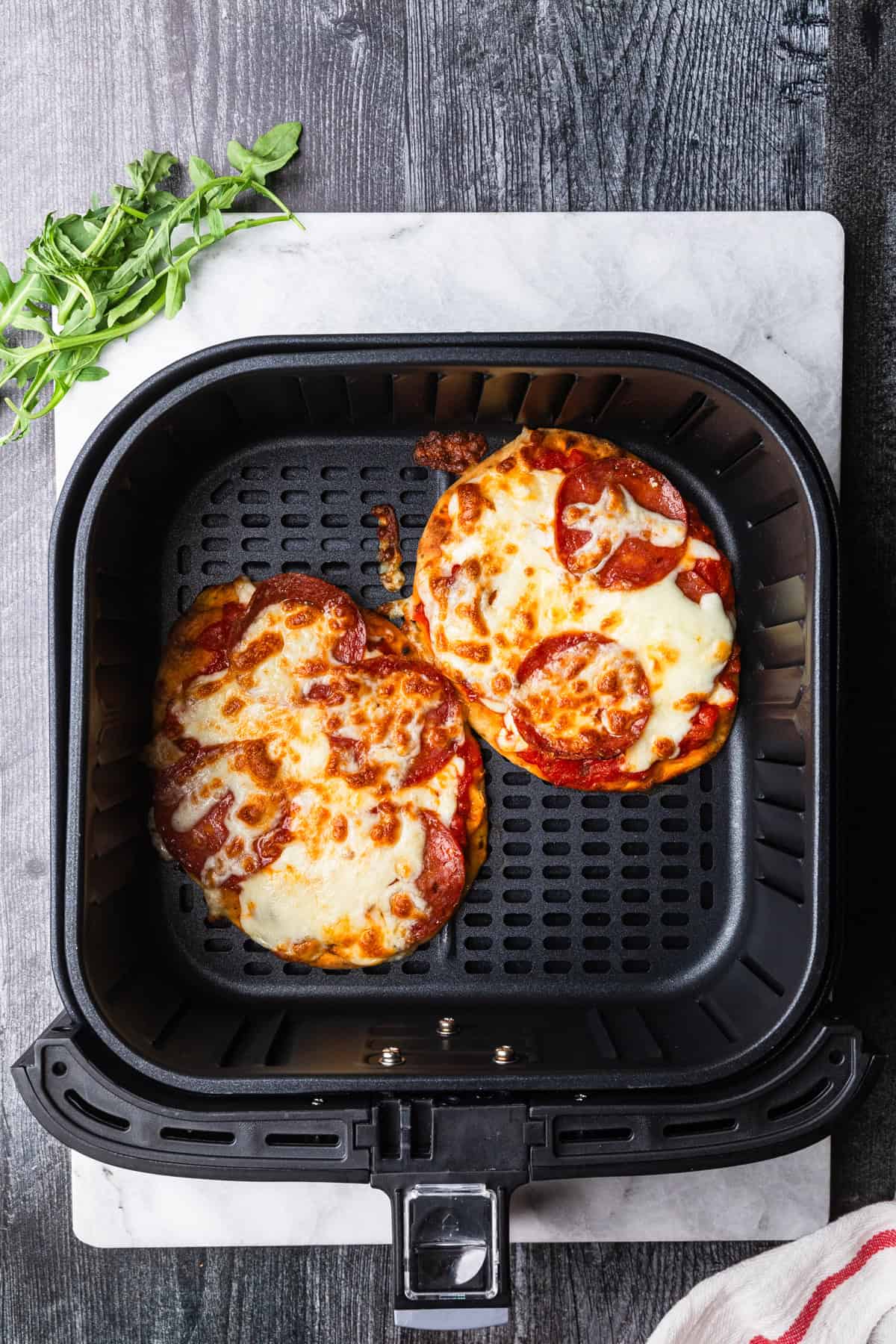 Air fryer pizza with golden brown melted cheese.