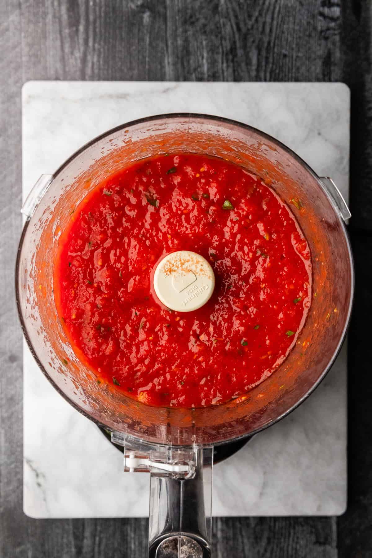 Making pizza sauce in a food processor.