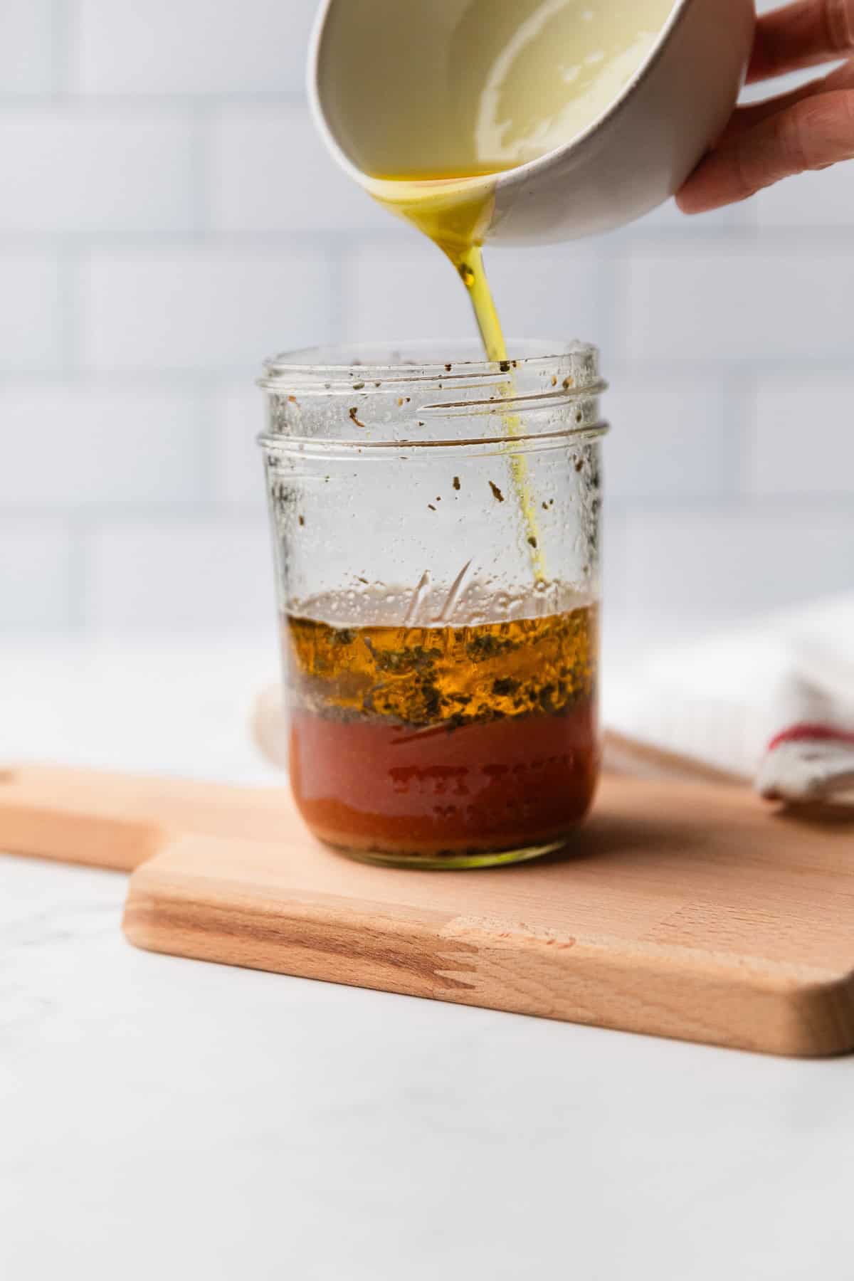 Add olive oil to mason jar.