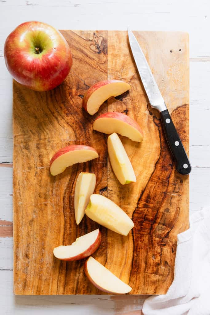 Apple slices on a cutting board.