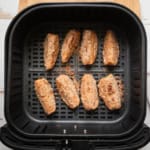 Apple slices in an air fryer basket.