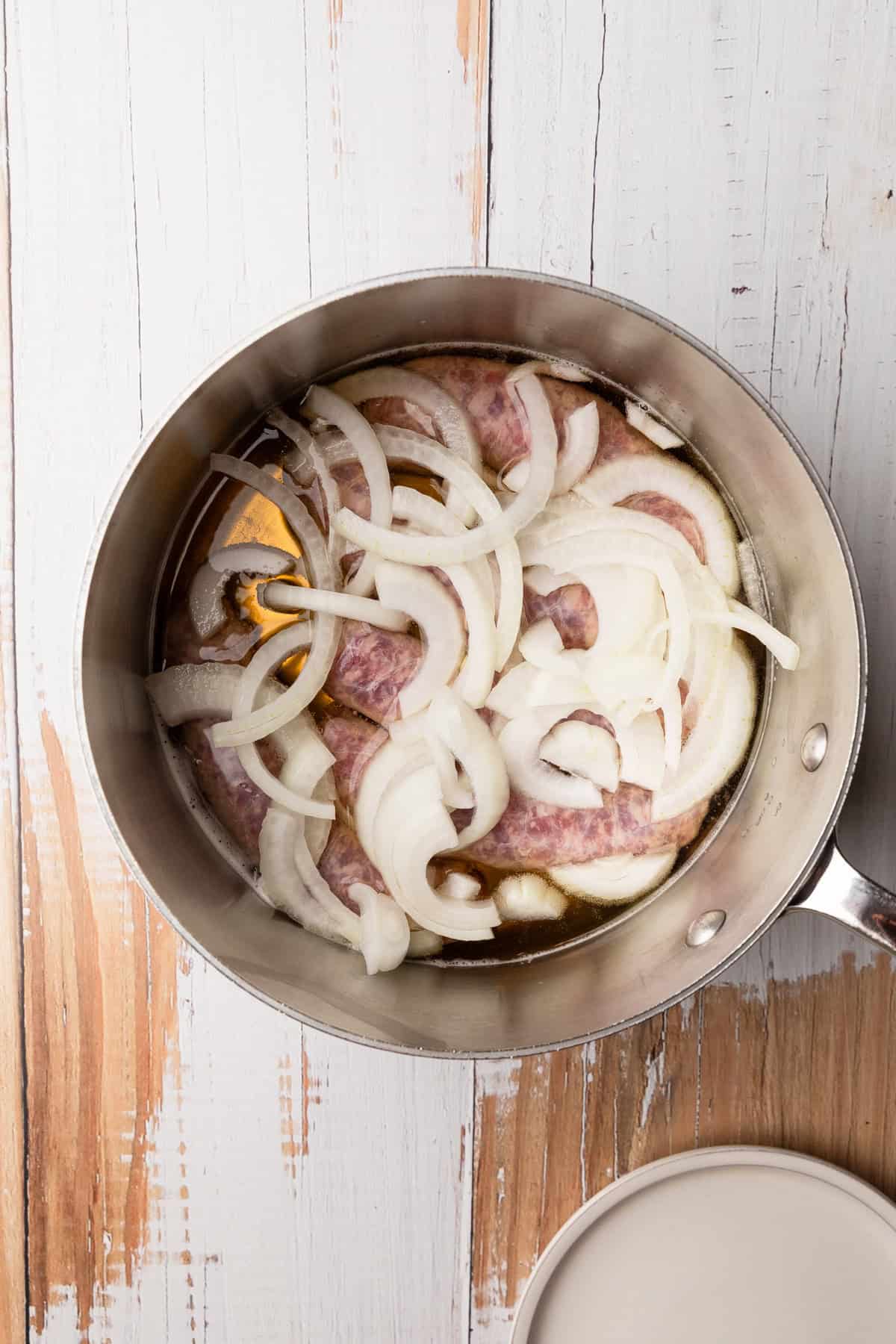 Cooking brats with beer and onions.