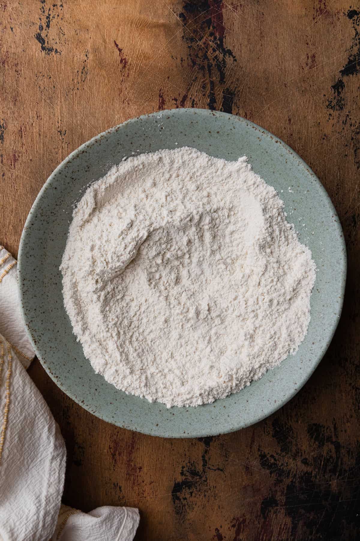 Mixing flour in a bowl.