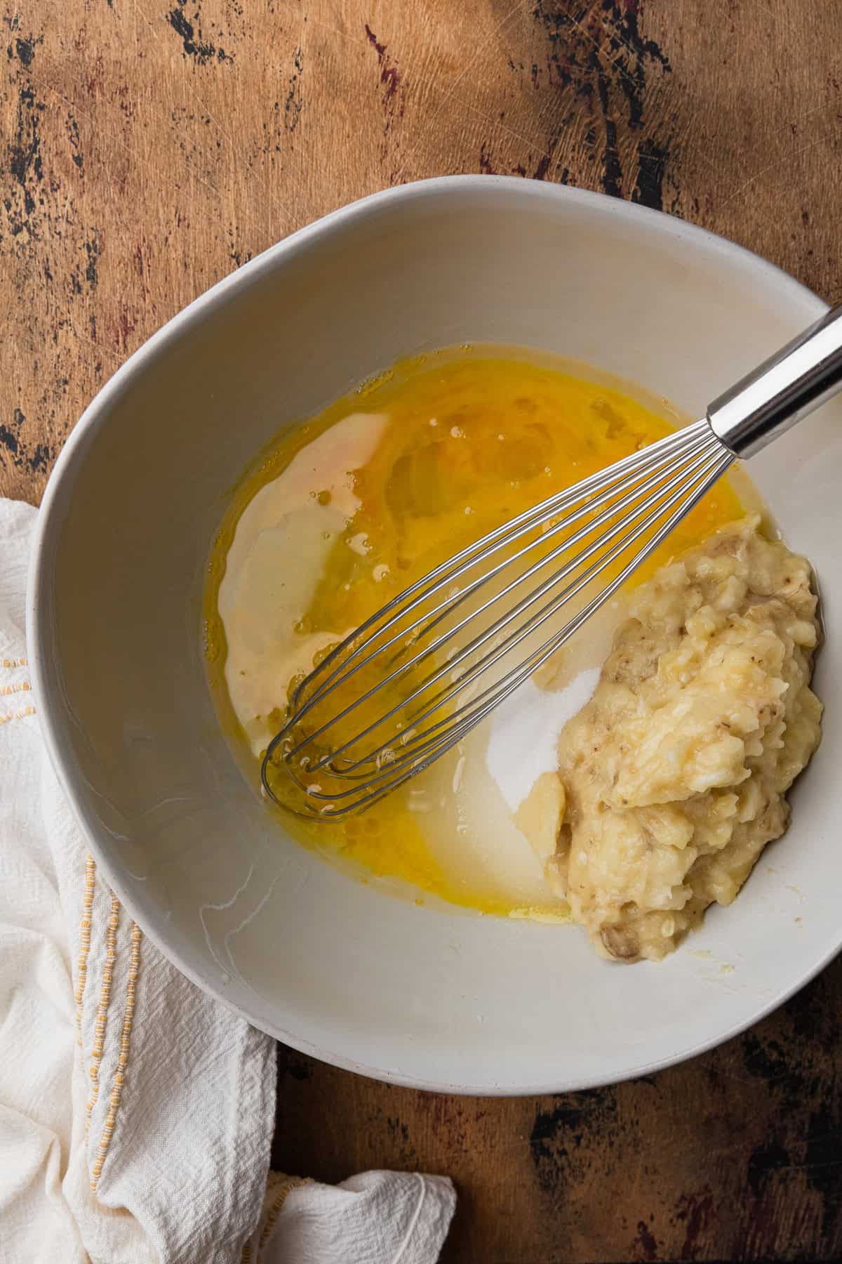 Mixing wet ingredient to make banana bread.