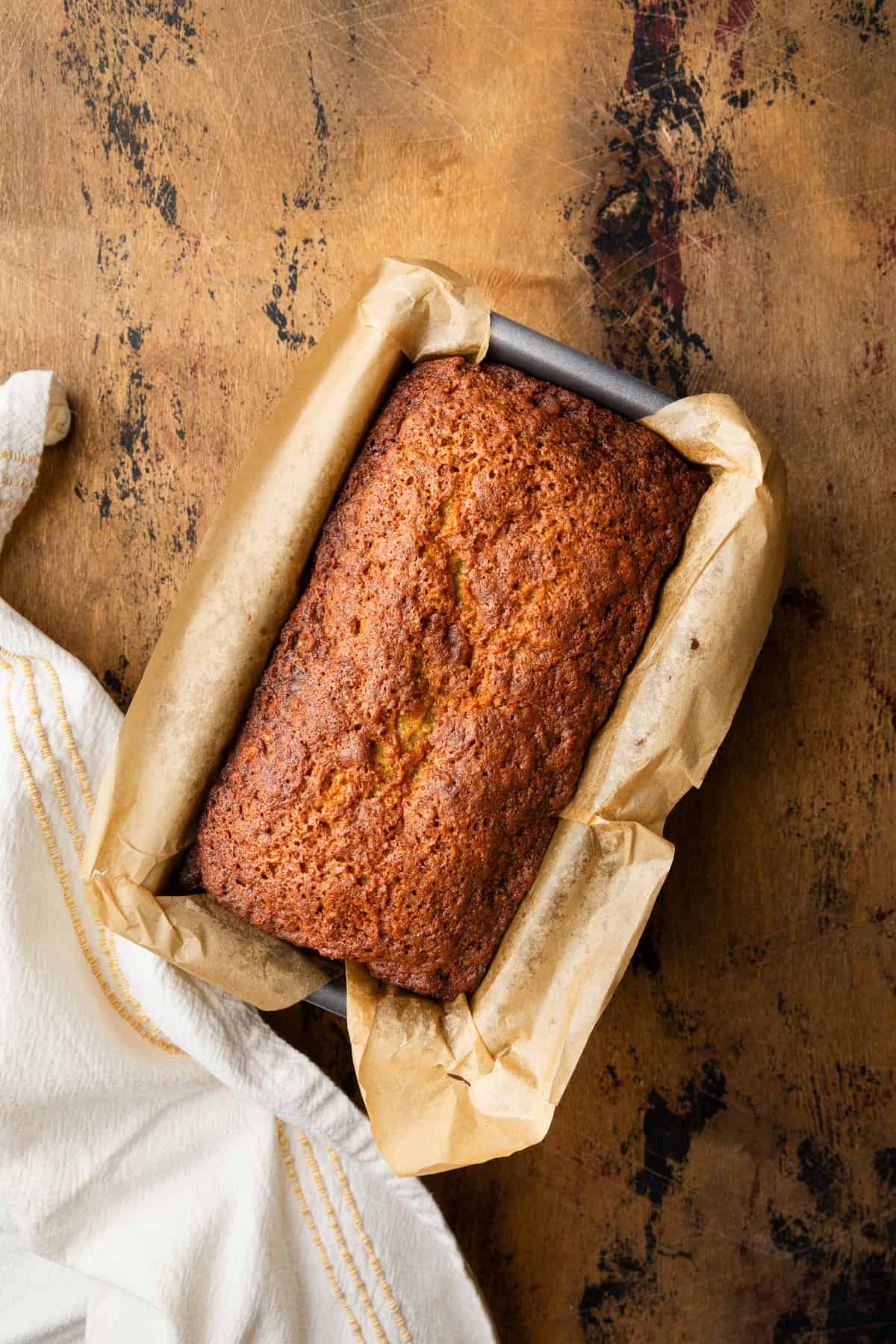 Freshly cooked banana bread in a loaf pan.