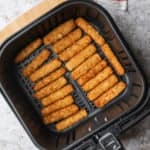 Air fryer fish sticks in the basket.