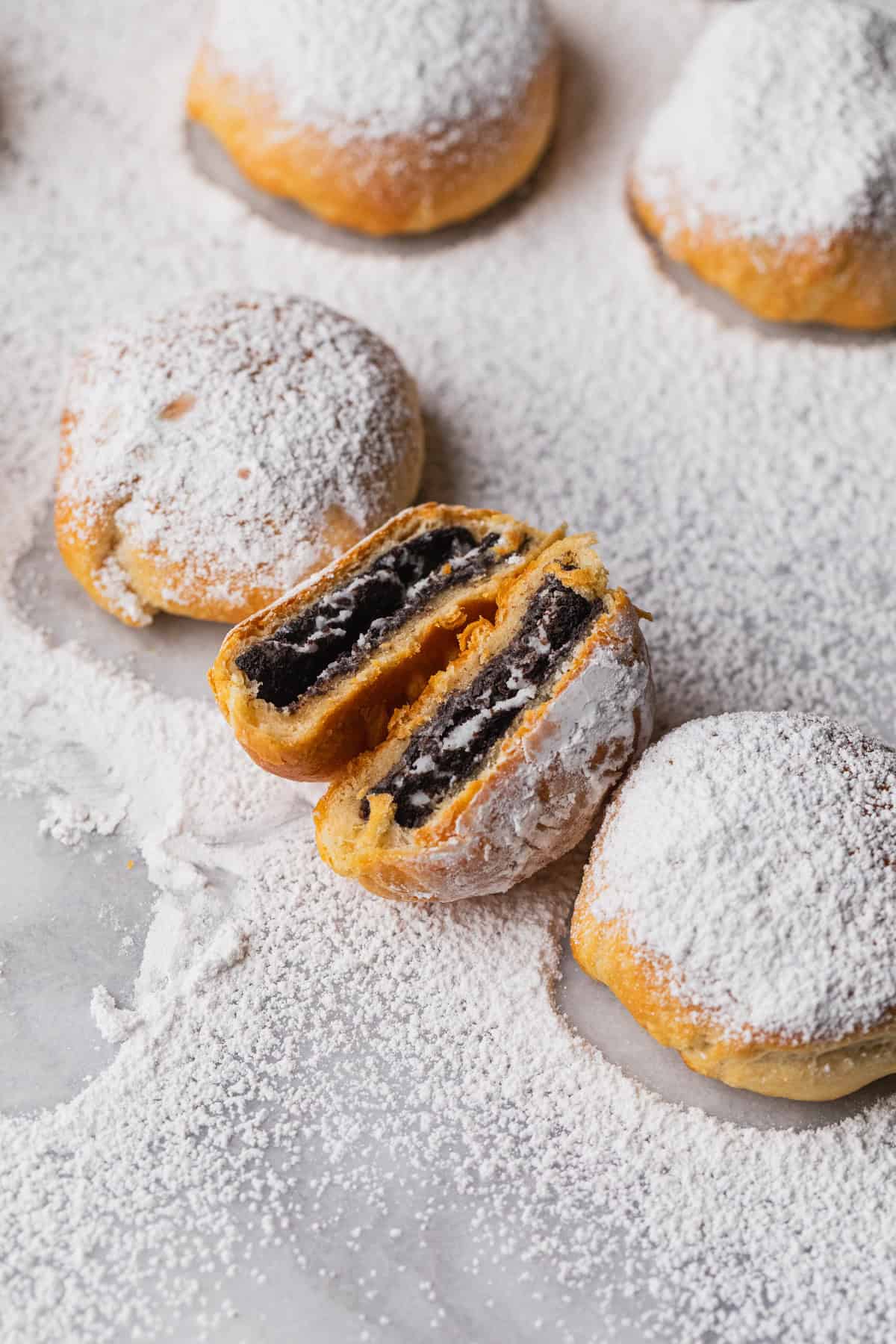 Some air fried oreo cookies on a marble cutting board.