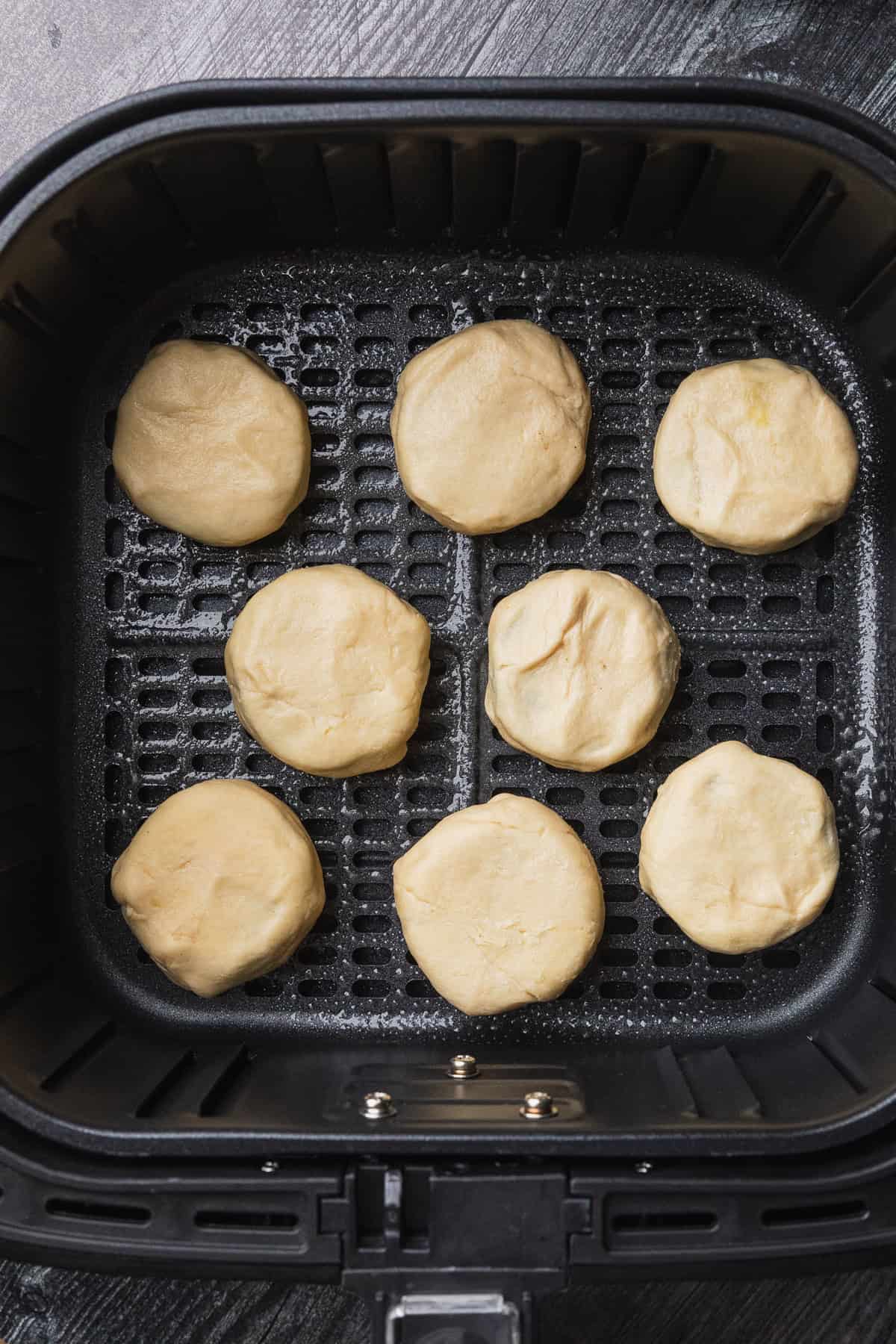 The uncooked oreos in the air fryer basket.