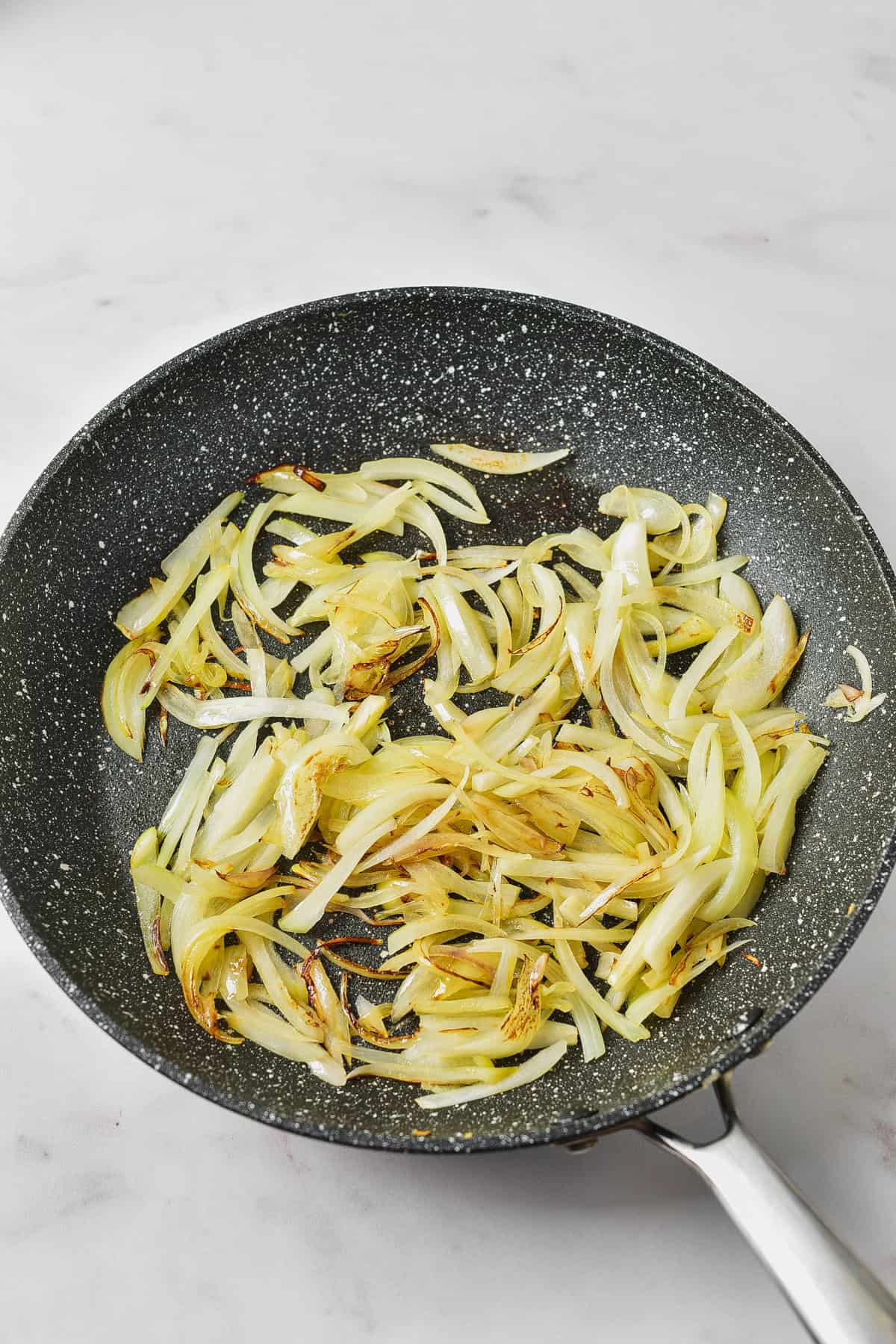 Cooking onions in a skillet.