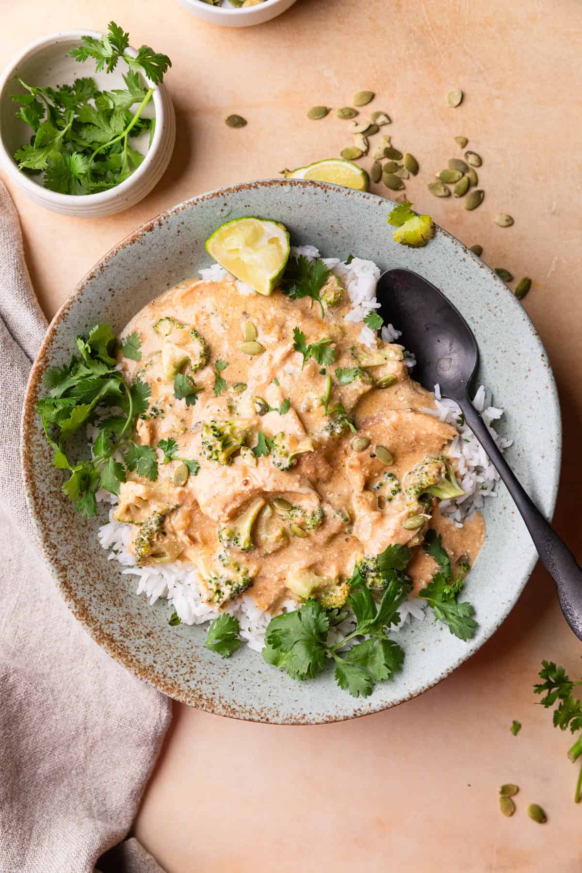 Crockpot chicken broccoli meal over rice in a bowl.