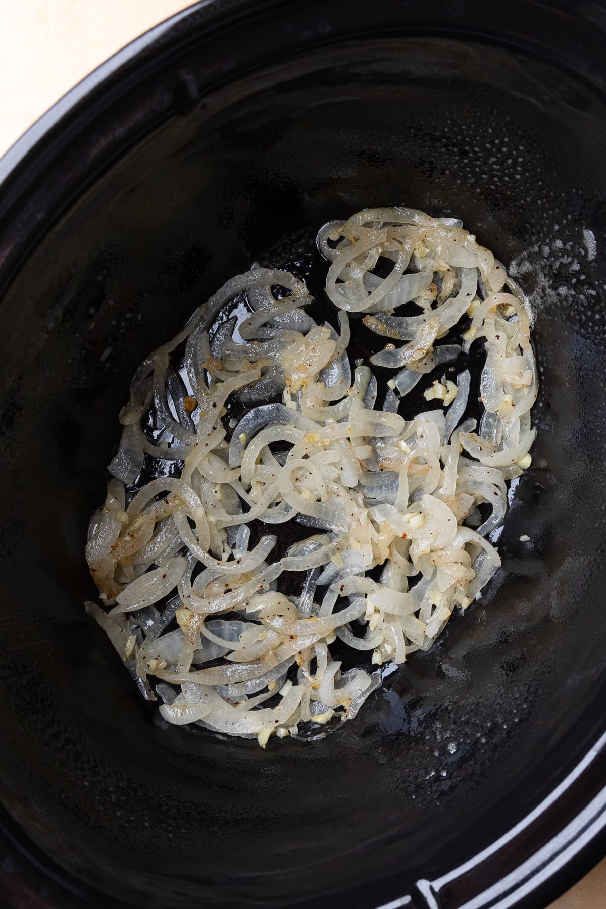 Cooked onions in a crockpot.