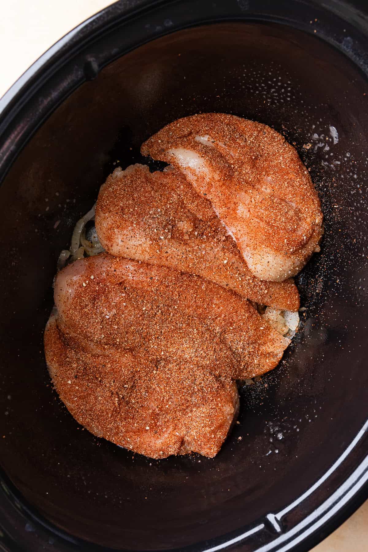 Seasoned chicken in crockpot.