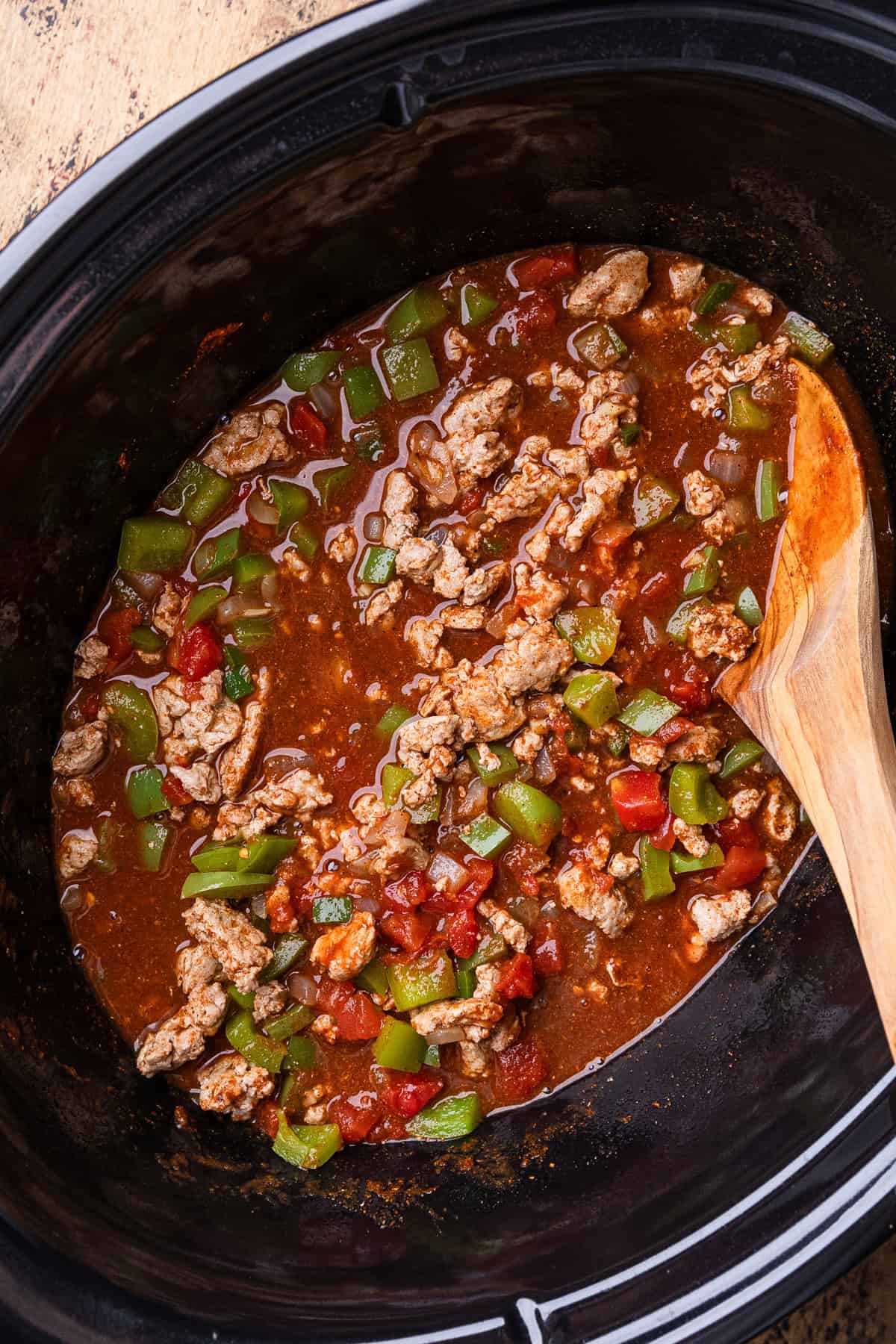 Turkey chili being stirred.