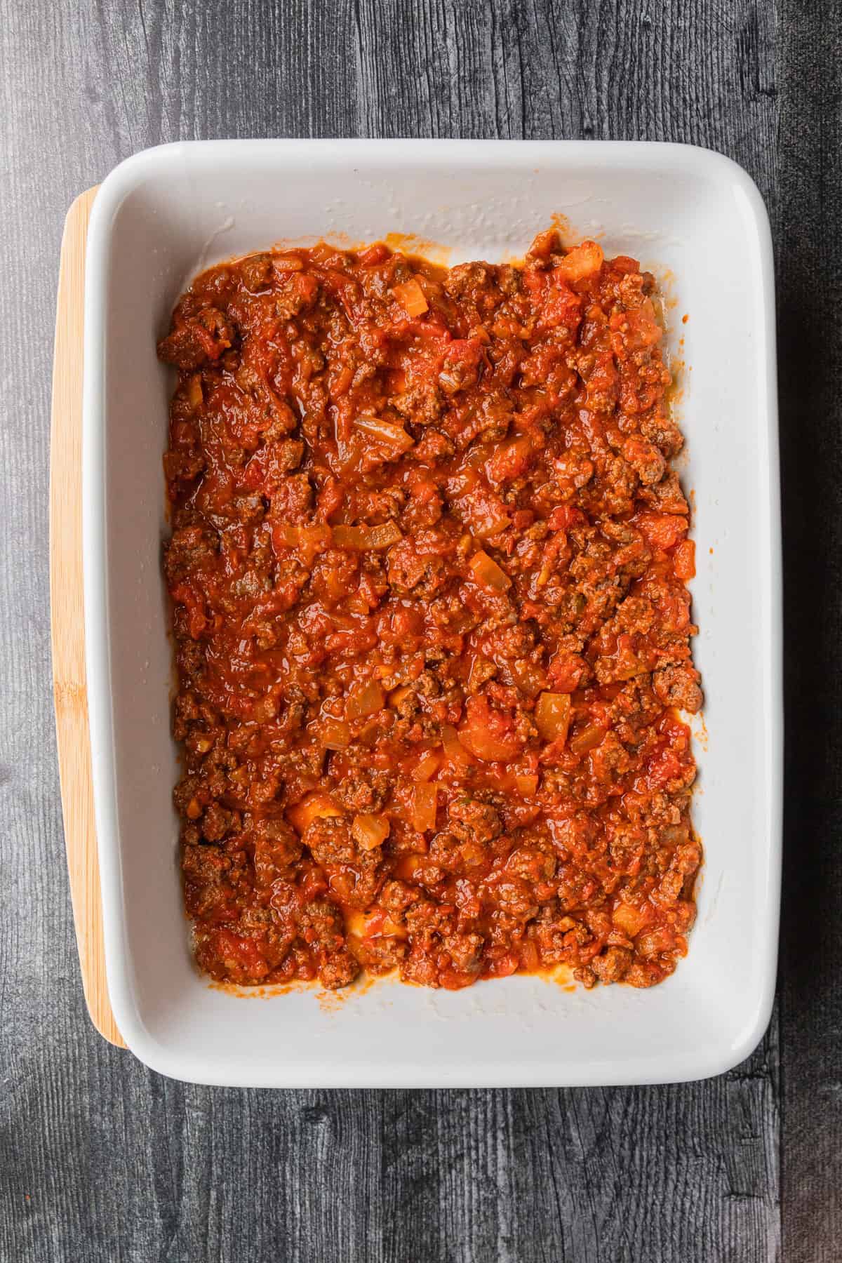 Meat sauce on the bottom of a baking pan.