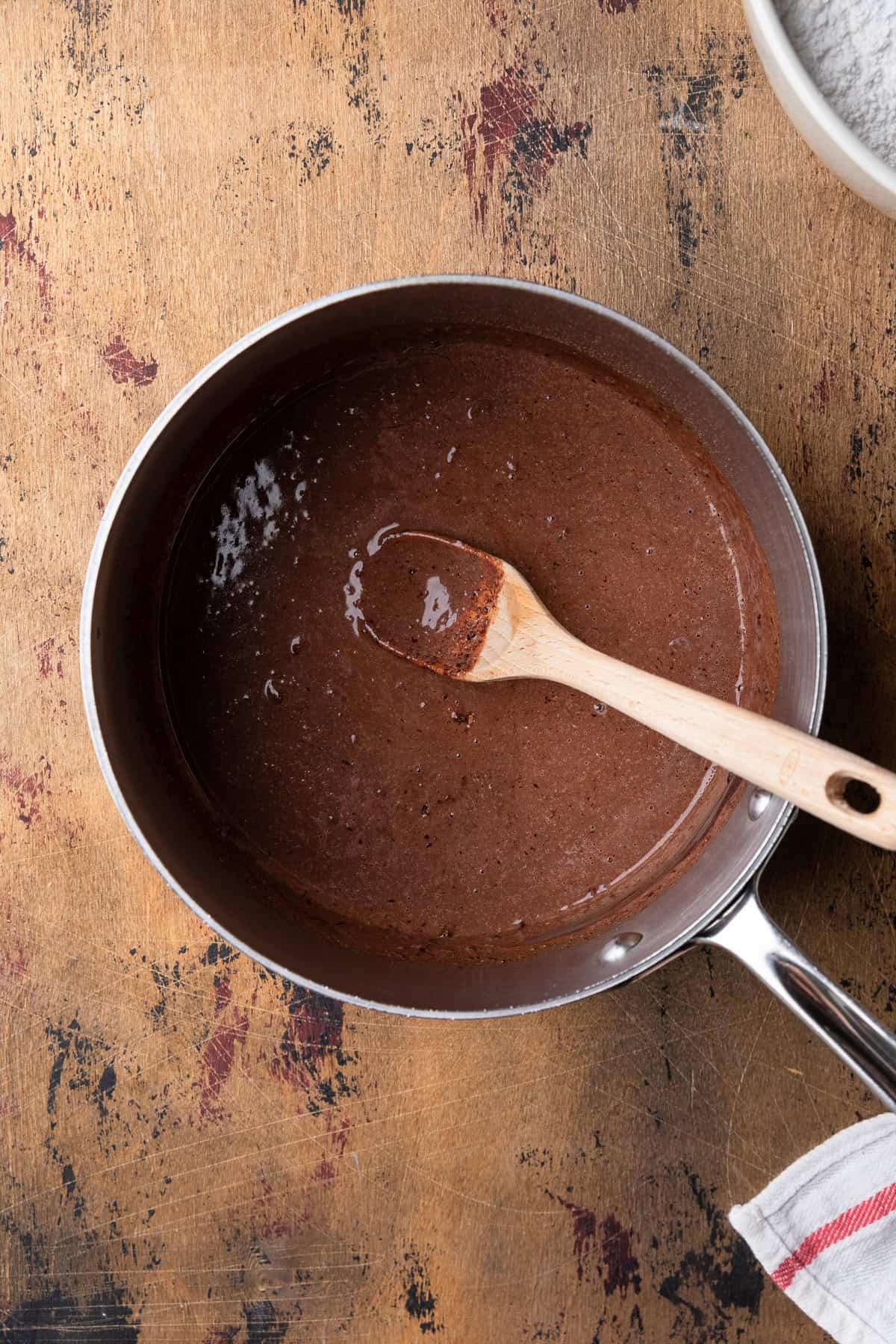 Mixing frosting ingredients in a saucepan.