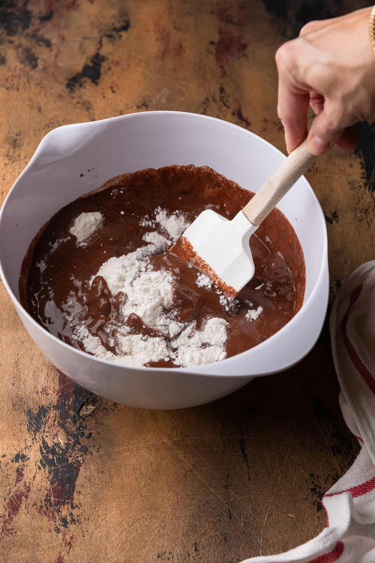 Mixing wet and dry cake ingredients.