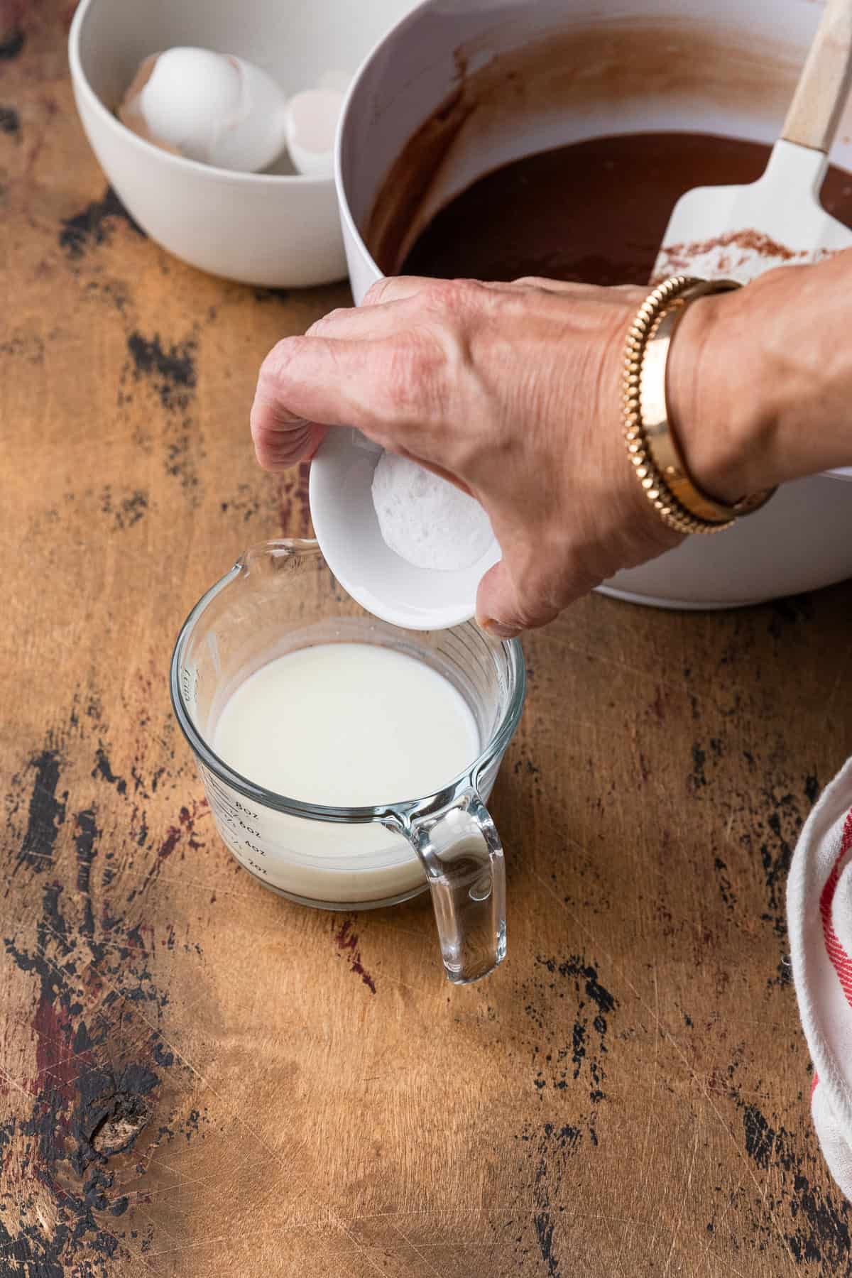 Mixing baking soda and buttermilk.