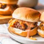 Air fryer slider on a plate with burger sauce dripping over the patty.