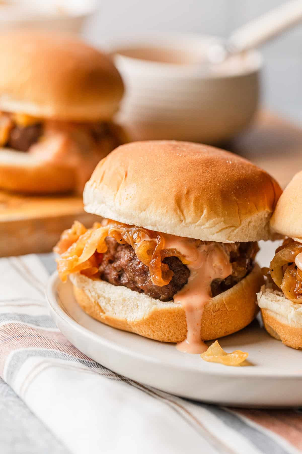 A cheeseburger slder on a plate.