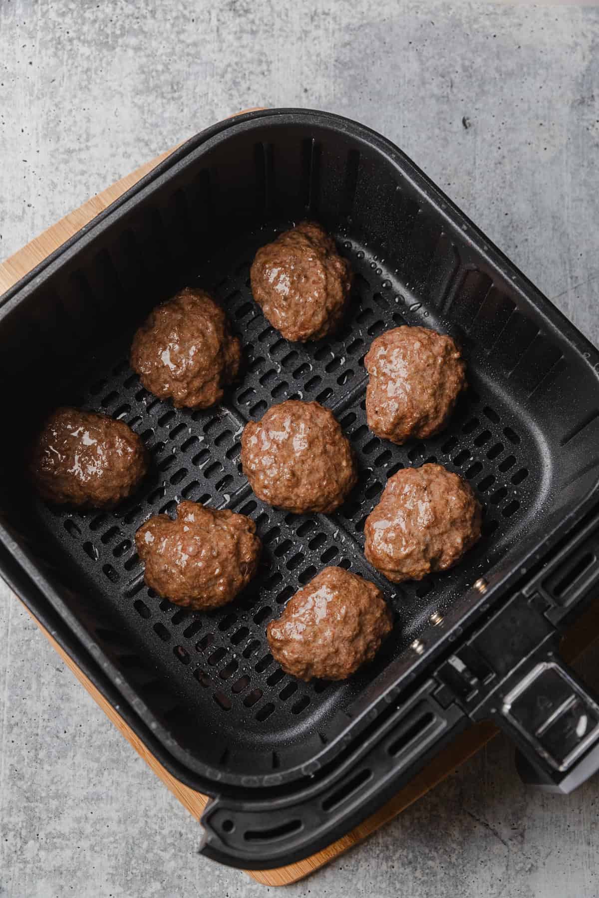 Cooked slider patties in basket.