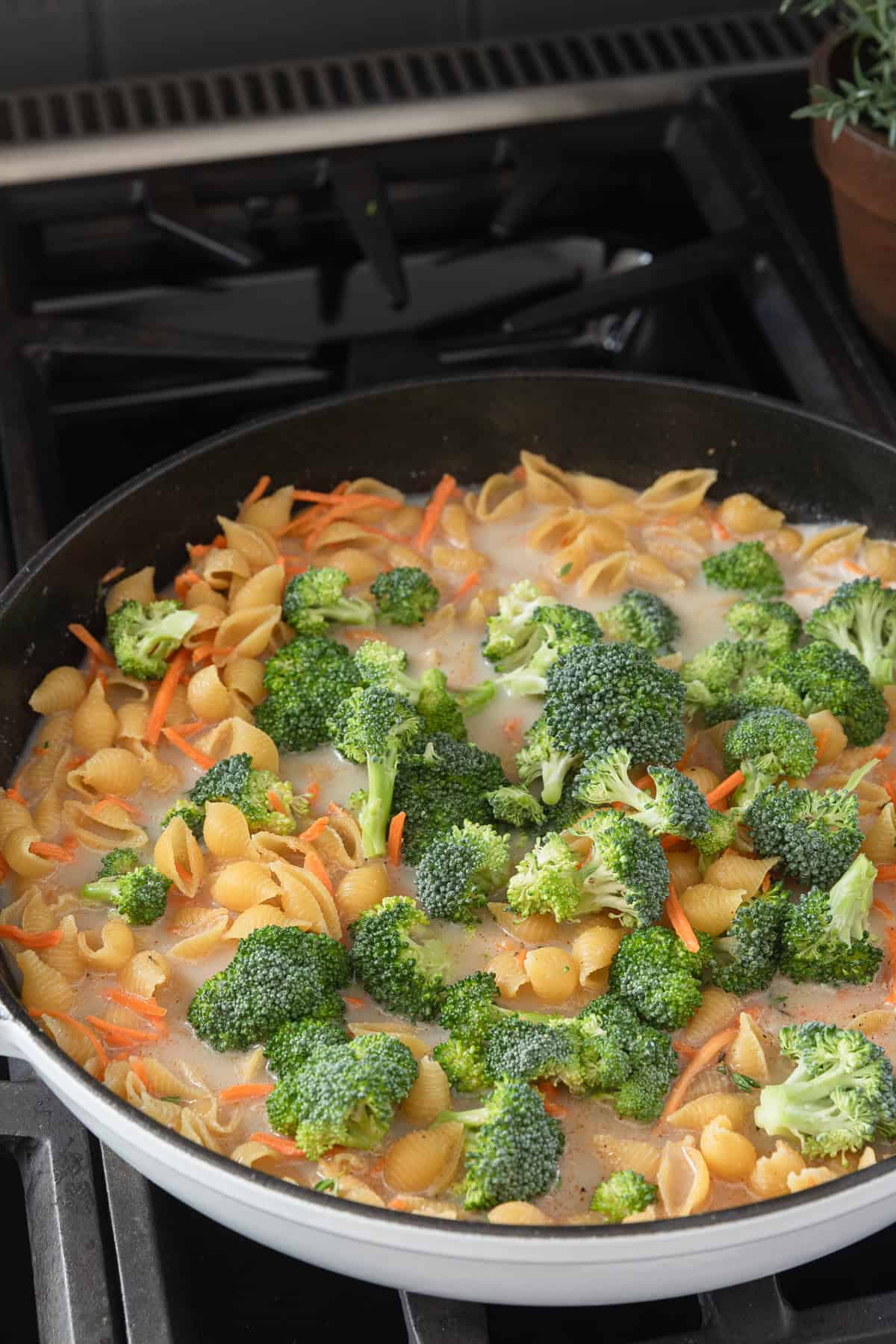 Adding broccoli to the skillet.