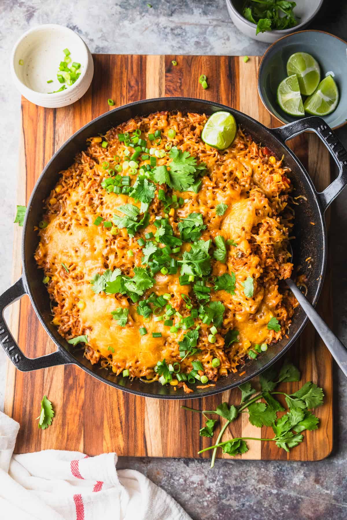 Ground beef salsa rice prepared in a skillet with garnishes.