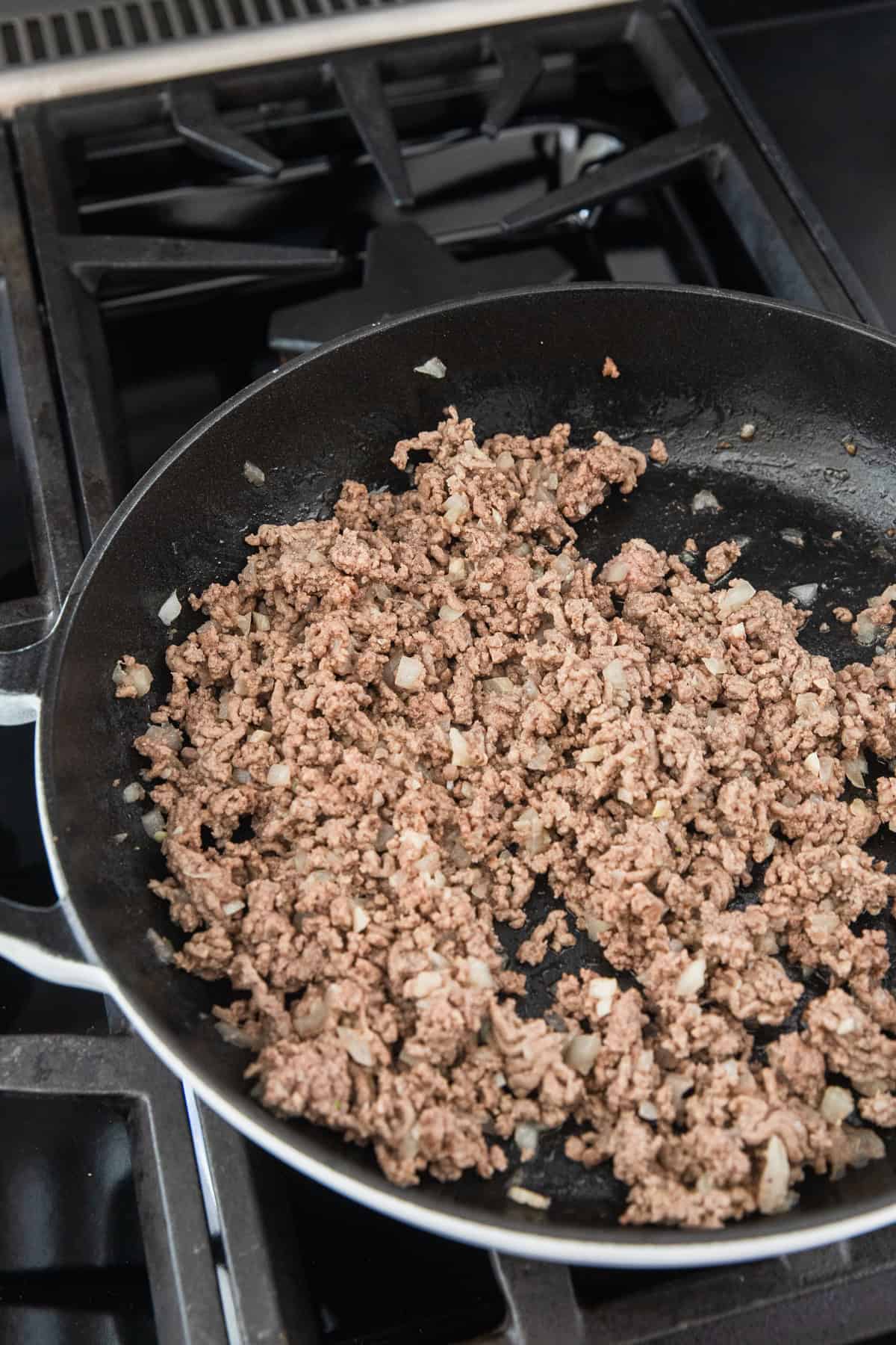 Cooking ground beef.