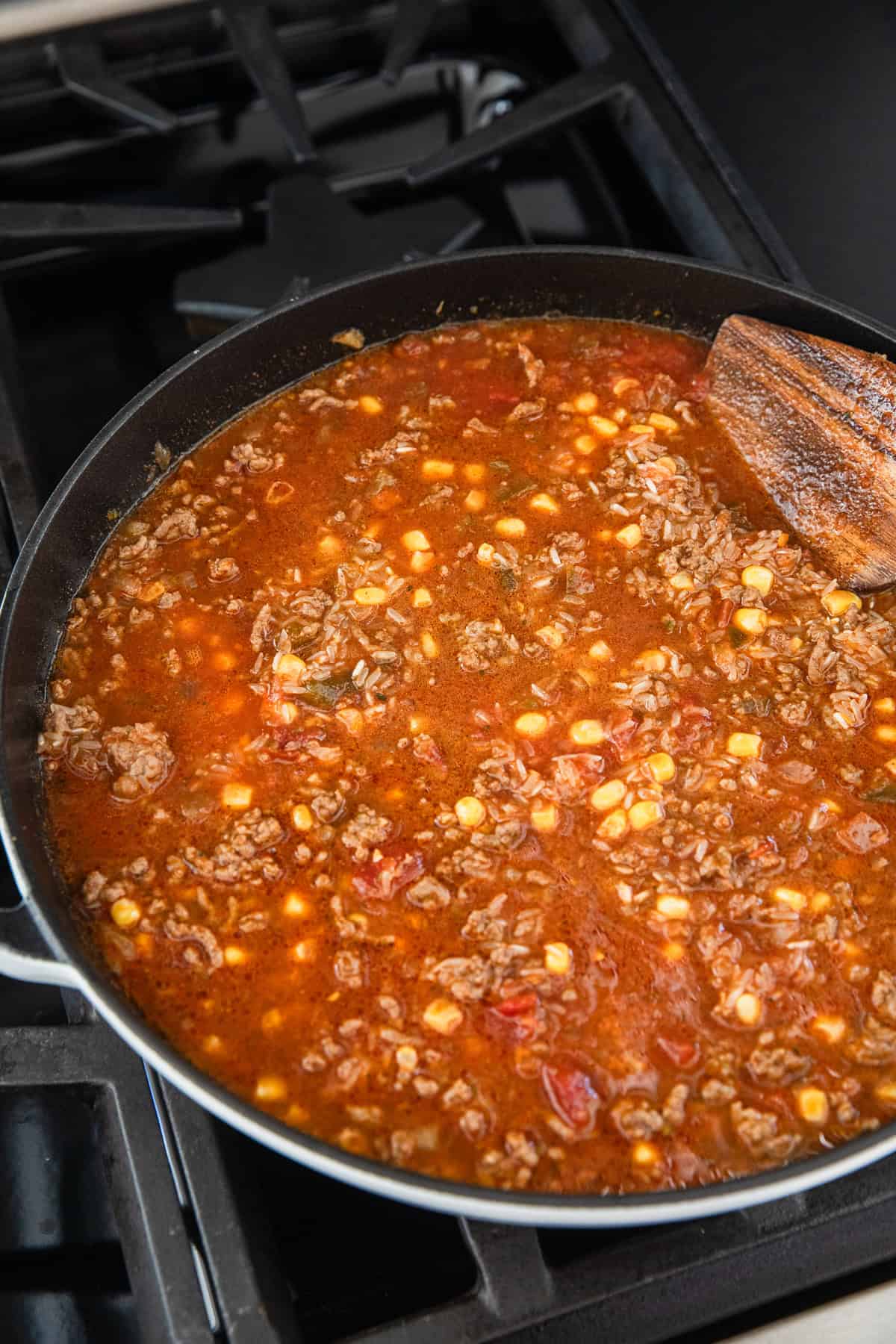 Adding ingredients to the ground beef.