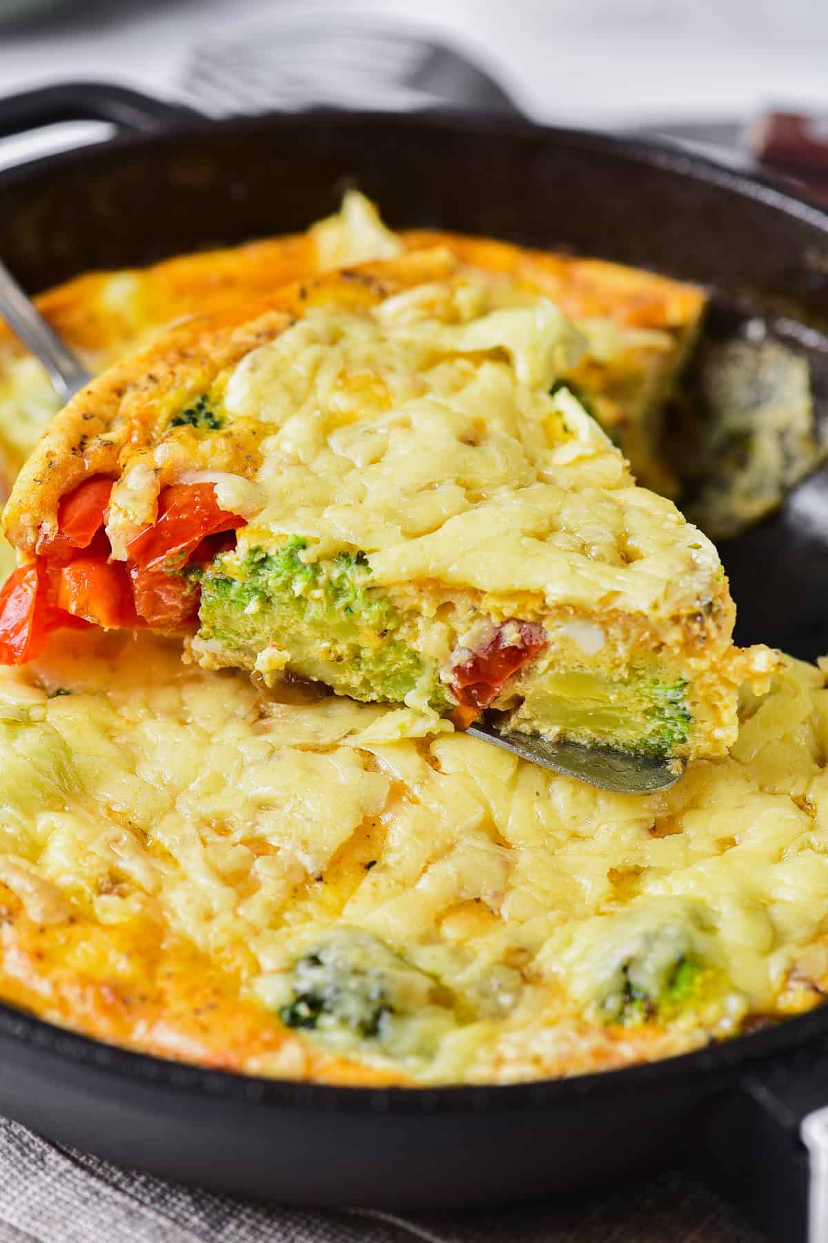 Taking an individual wedge of frittata from the cast iron skillet.