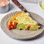 Healthy vegetable frittata wedge on a plate.