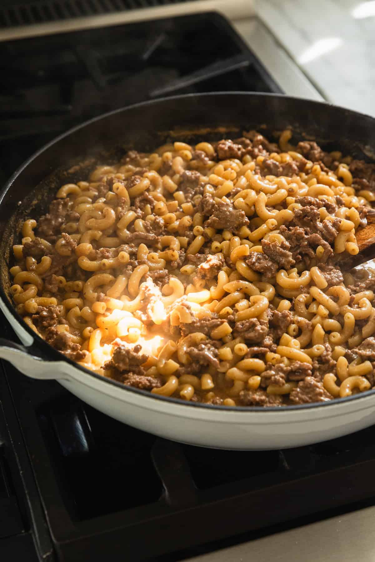 The recipe in a skillet after macaroni is tender.