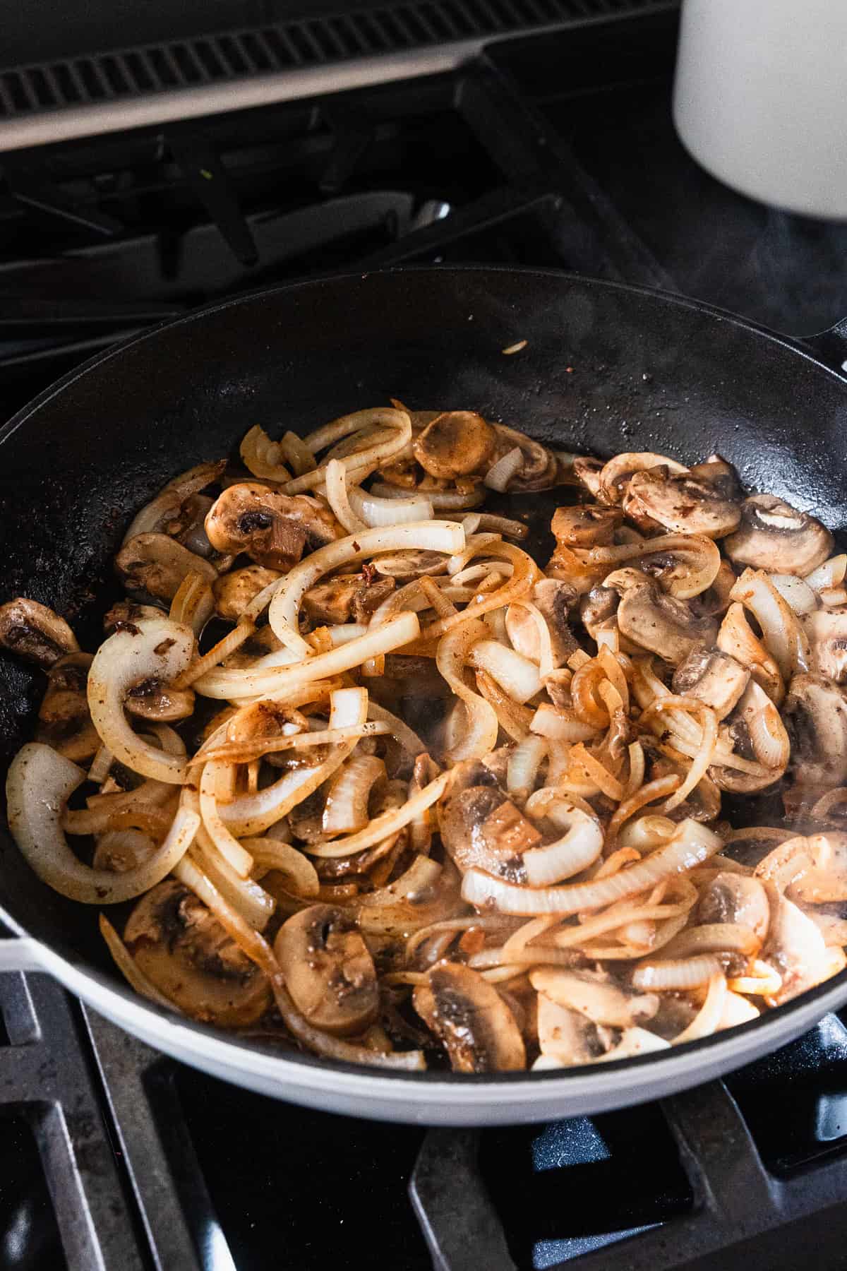 Cooked mushrooms and onions in the skillet.