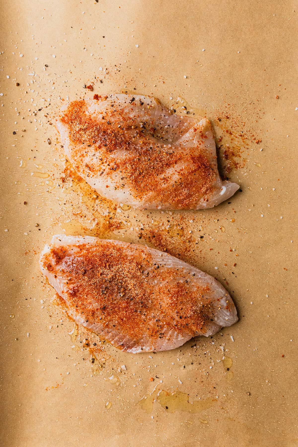 Seasoning frozen tilapia filets.