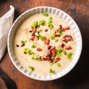 Potato soup made with evaporated milk topped with fried ham pieces.