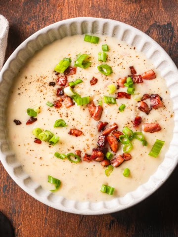 Potato soup made with evaporated milk topped with fried ham pieces.