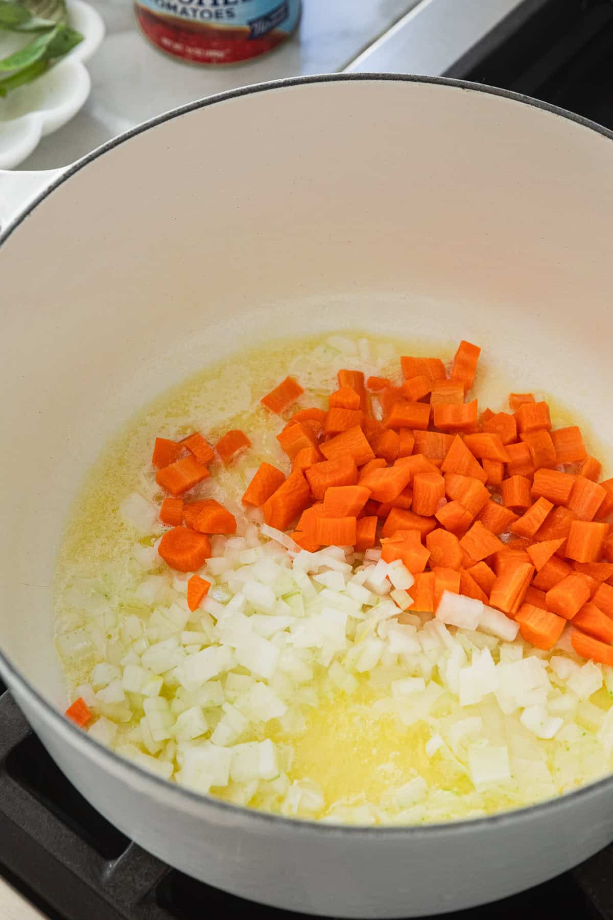 Cooking onions and carrots in oil and butter.