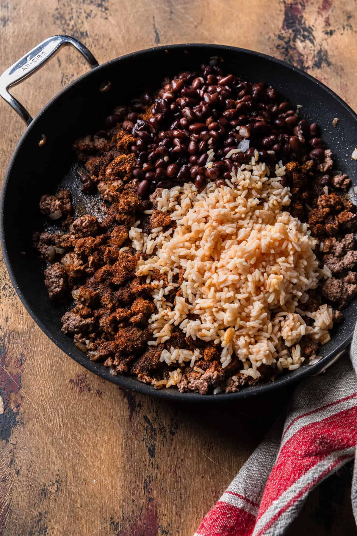 Mixing the taco meat, rice and black beans.