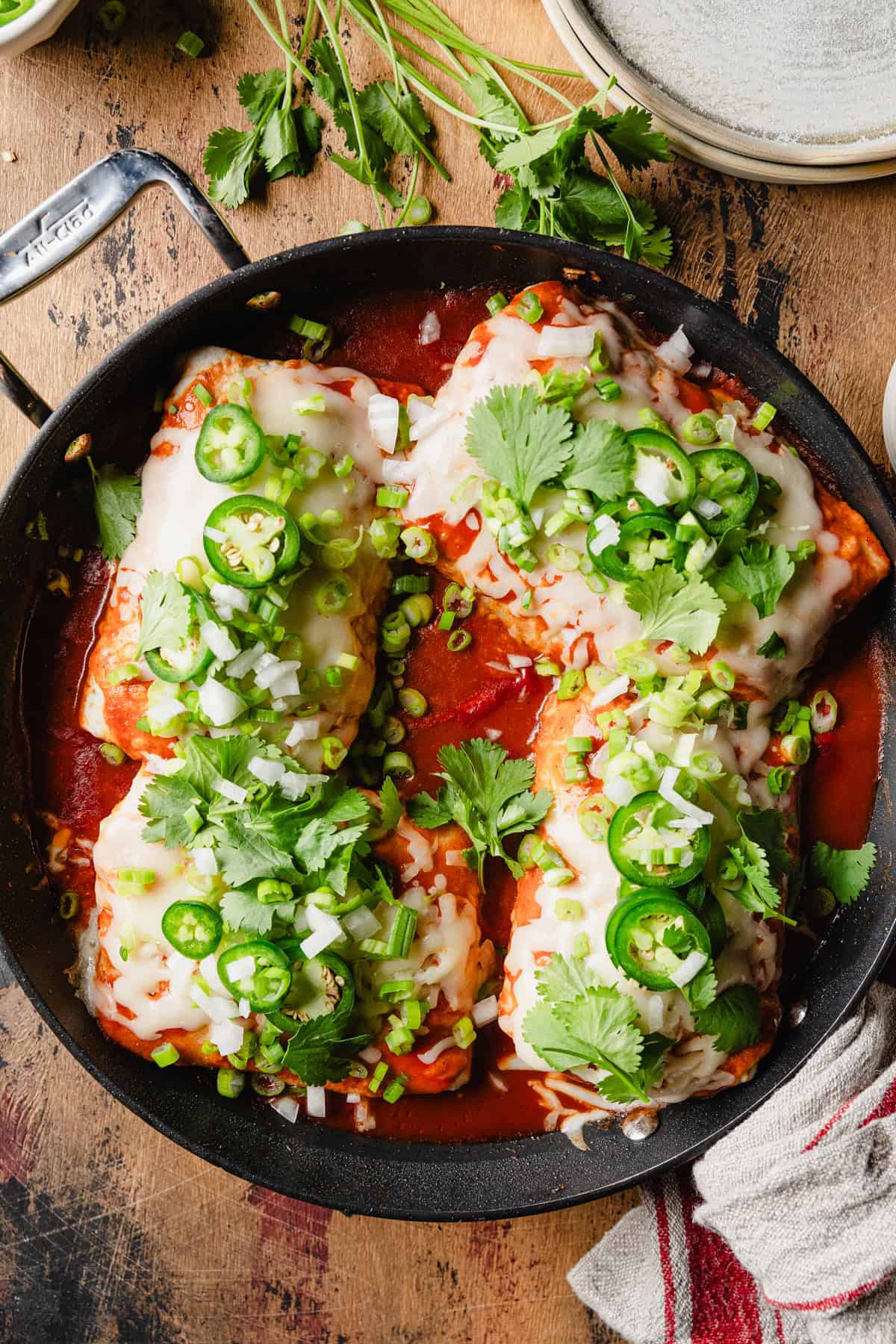 The wet burritos topped with jalapenos and cilantro.