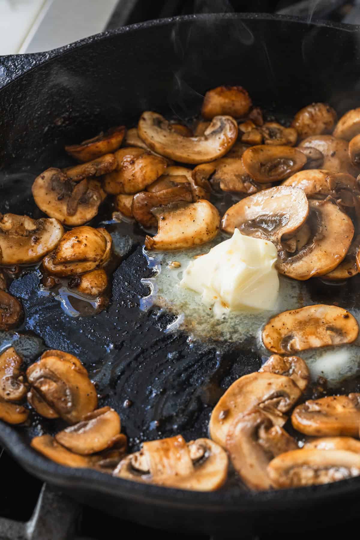 Making a mushroom pan sauce with butter.