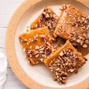 Graham cracker pralines on cut into squares and on a plate.