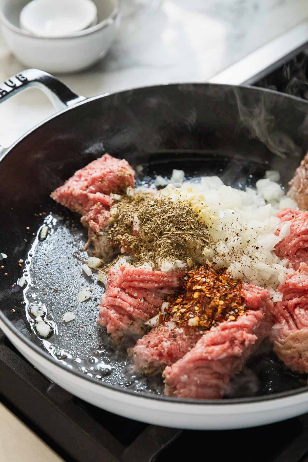 Cooking ground turkey and onions in a skillet.