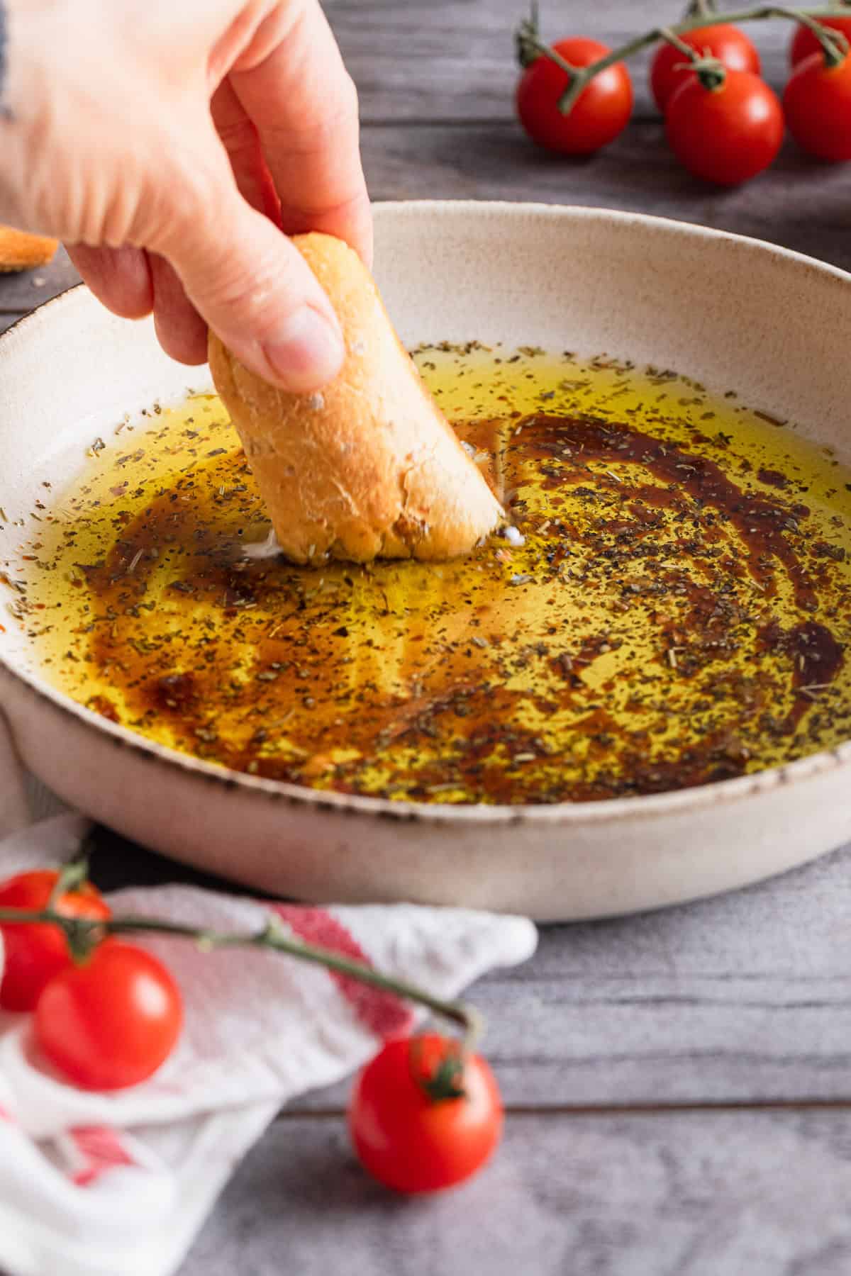 Dipping a breadstick into the prepared dip.