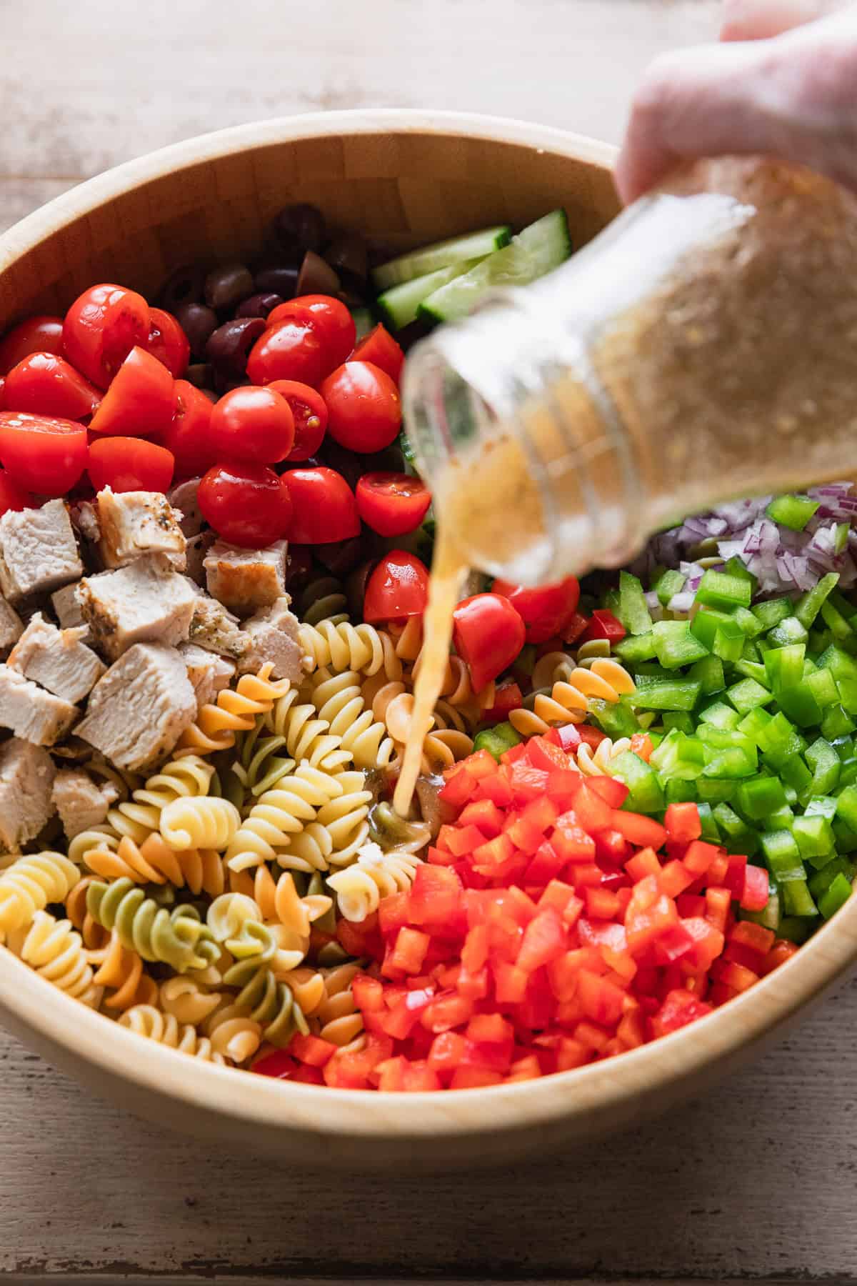 Pouring the dressing over the salad.